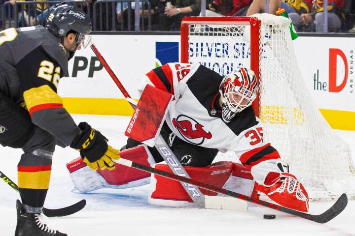 Golden Knights center Michael Amadio (22) shoots on New Jersey Devils goaltender Andrew Hammond ...