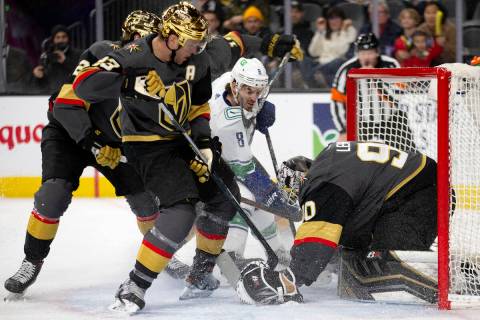 Golden Knights goaltender Robin Lehner (90) saves a shot by Canucks right wing Conor Garland (8 ...