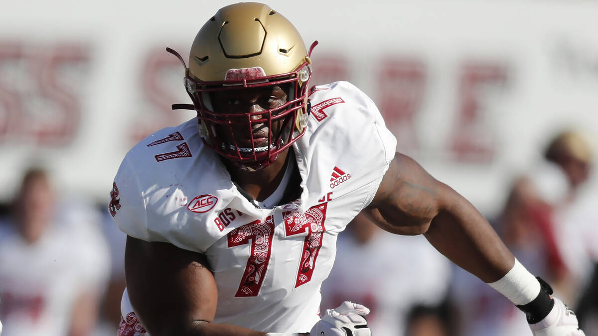 Boston College offensive lineman Zion Johnson (77) plays against Massachusetts during the first ...
