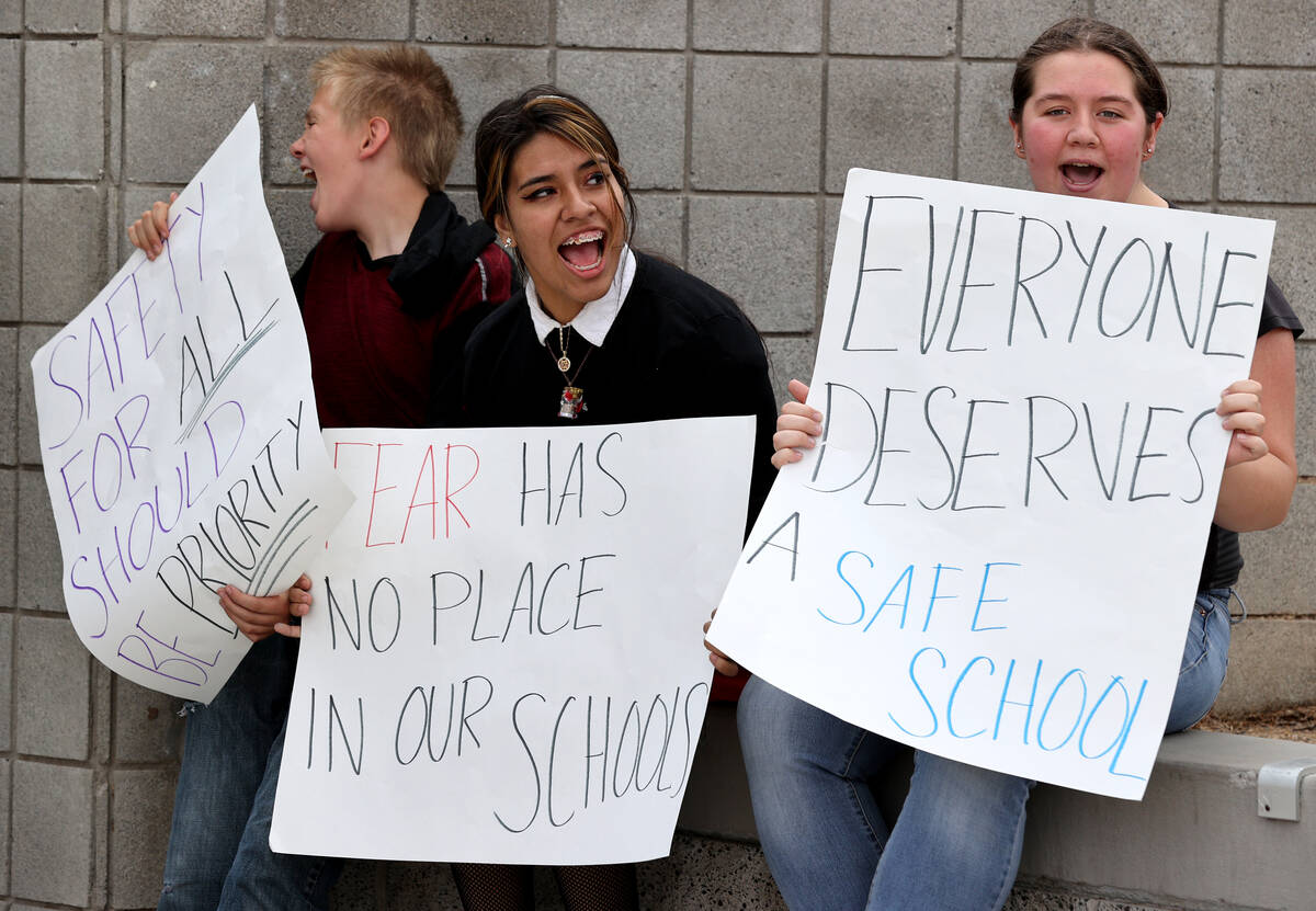 Students, from left, Brenden Sharp, 12, Leilani Rodriguez, 15, and Leslie Leonard, 17, protest ...
