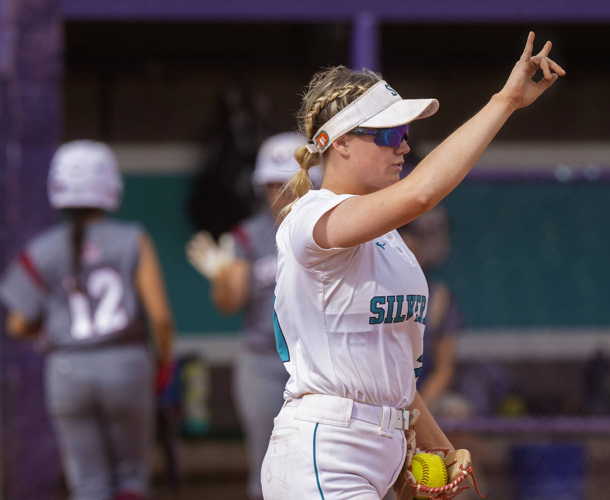 Silverado’s Macy Magdaleno (21) signals two outs during a girls high school softball gam ...