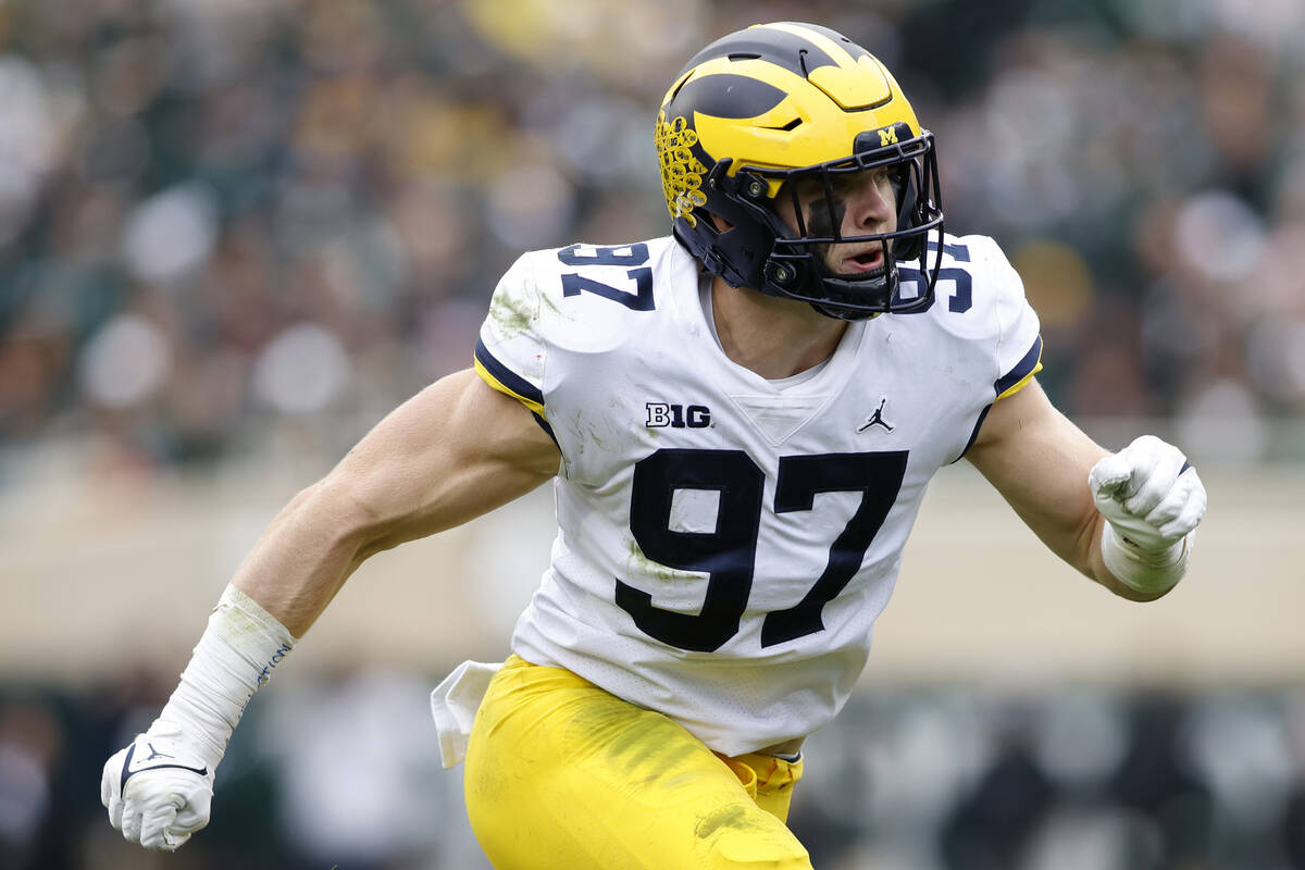 Michigan's Aidan Hutchinson plays during an NCAA college football game against Michigan State o ...