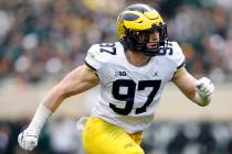 Michigan's Aidan Hutchinson plays during an NCAA college football game against Michigan State o ...