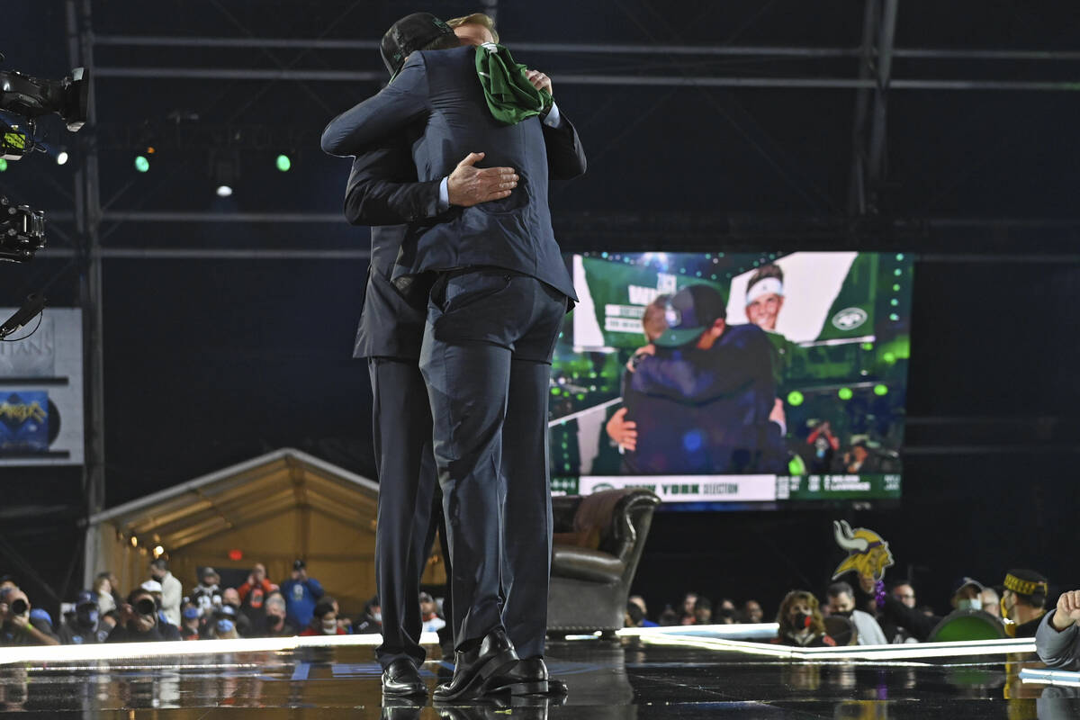 BYU quarterback Zach Wilson, right, hugs NFL Commissioner Roger Goodell after the New York Jets ...