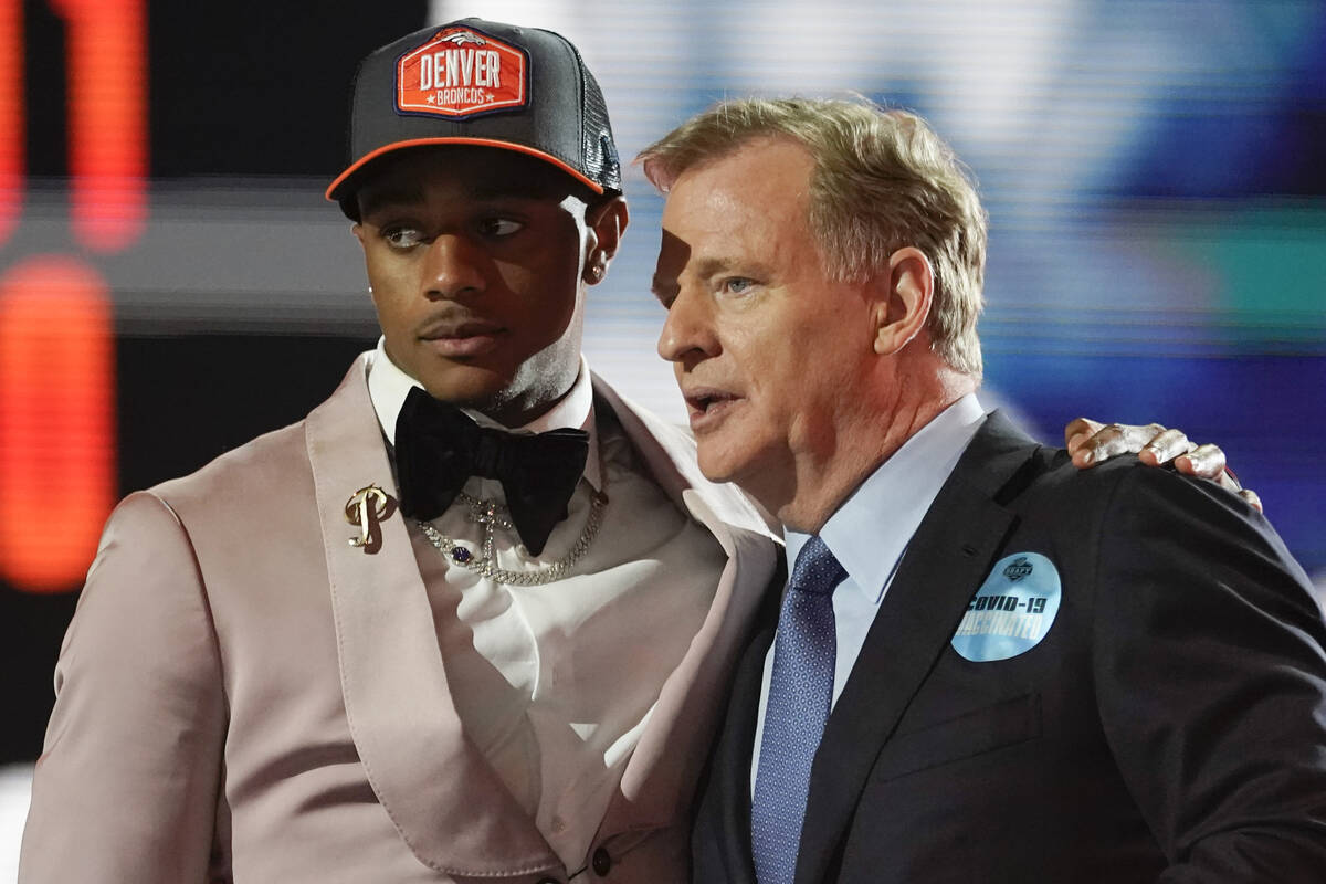 Alabama cornerback Patrick Surtain II, left, stands with NFL Commissioner Roger Goodell after t ...