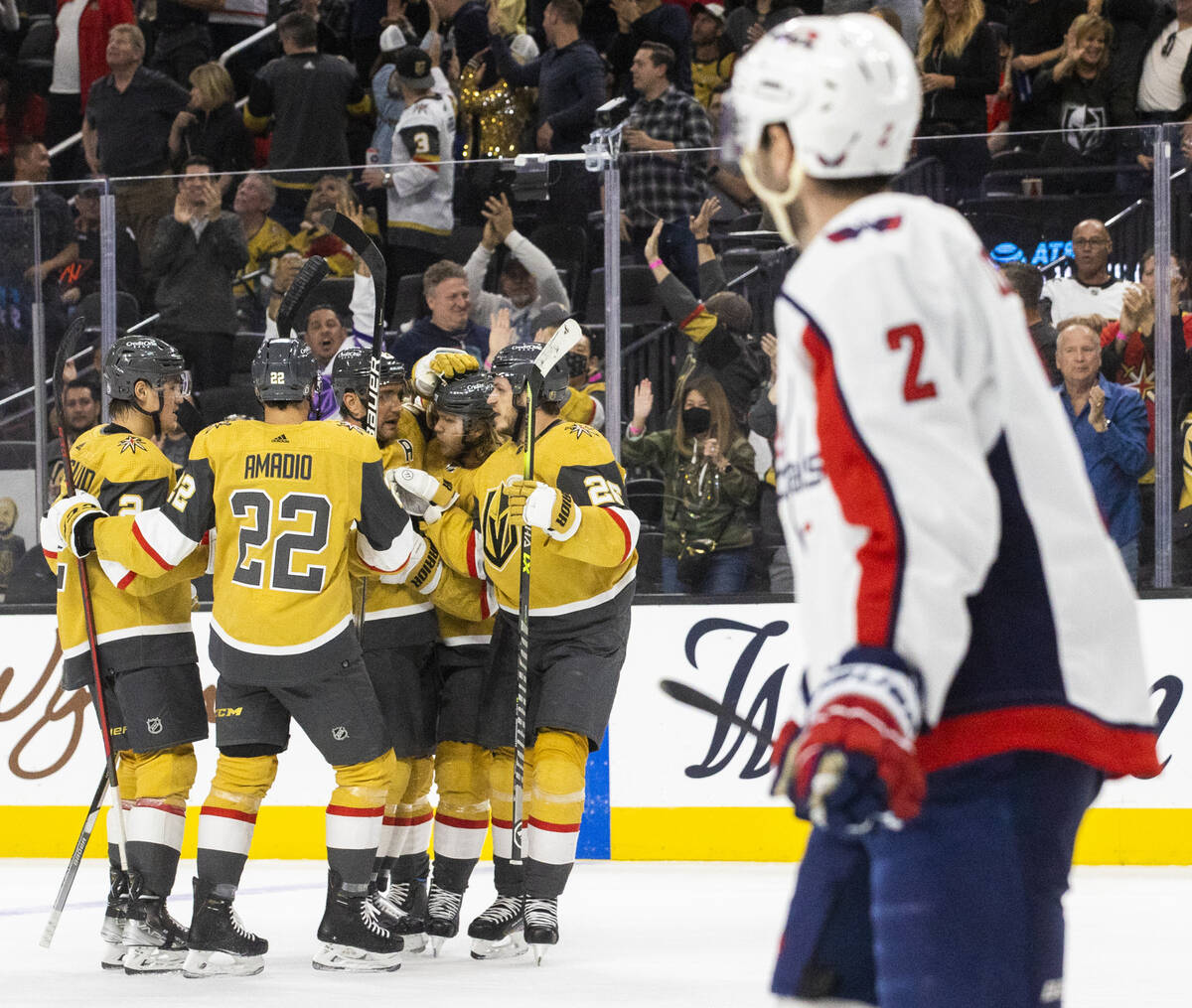 Golden Knights players celebrate a goal by teammate Alec Martinez (23) in the first period duri ...