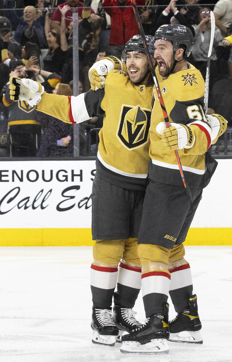 Golden Knights center Chandler Stephenson (20) celebrates with Golden Knights right wing Mark S ...