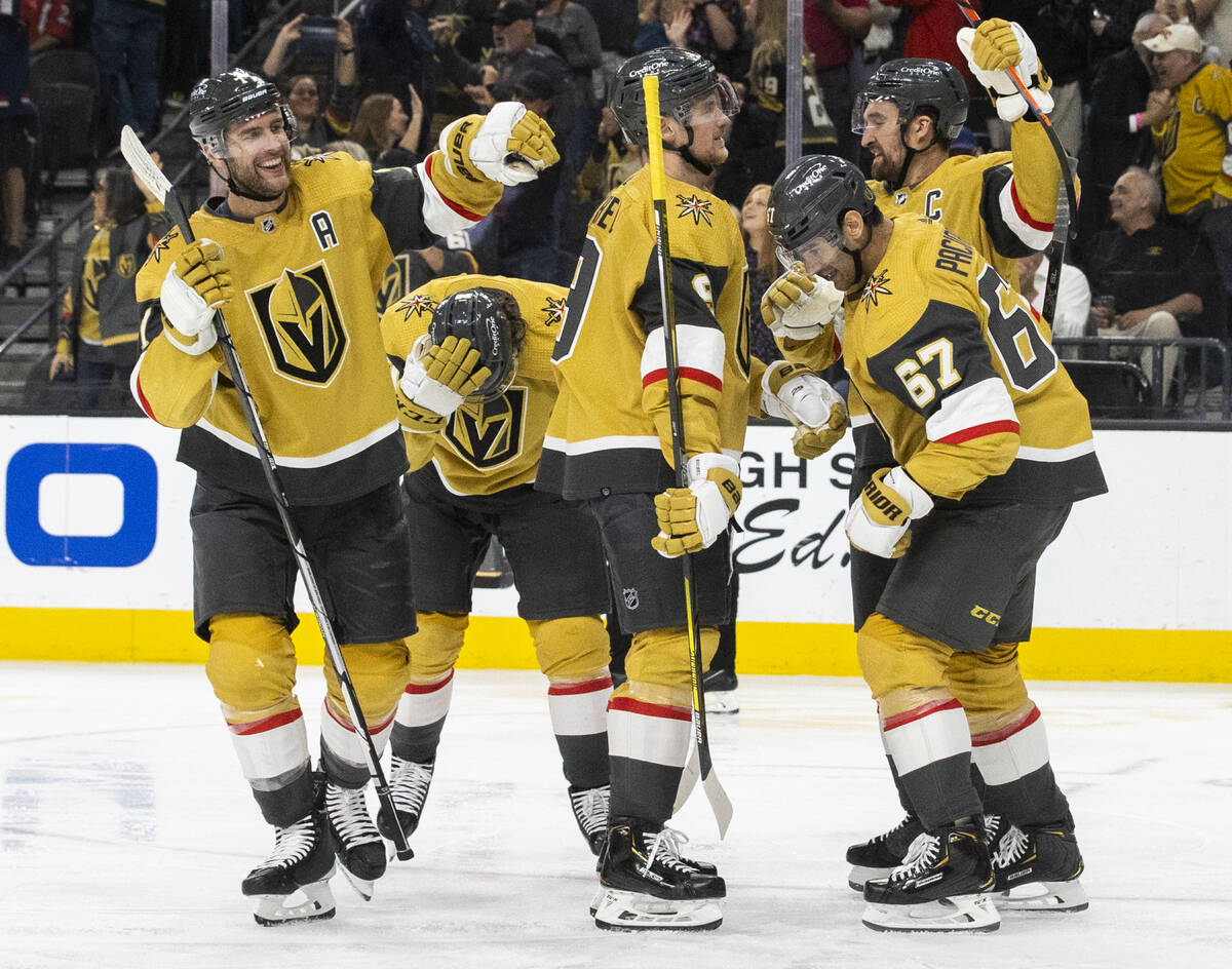 Golden Knights players celebrate a third period goal by Chandler Stephenson (20) during an NHL ...
