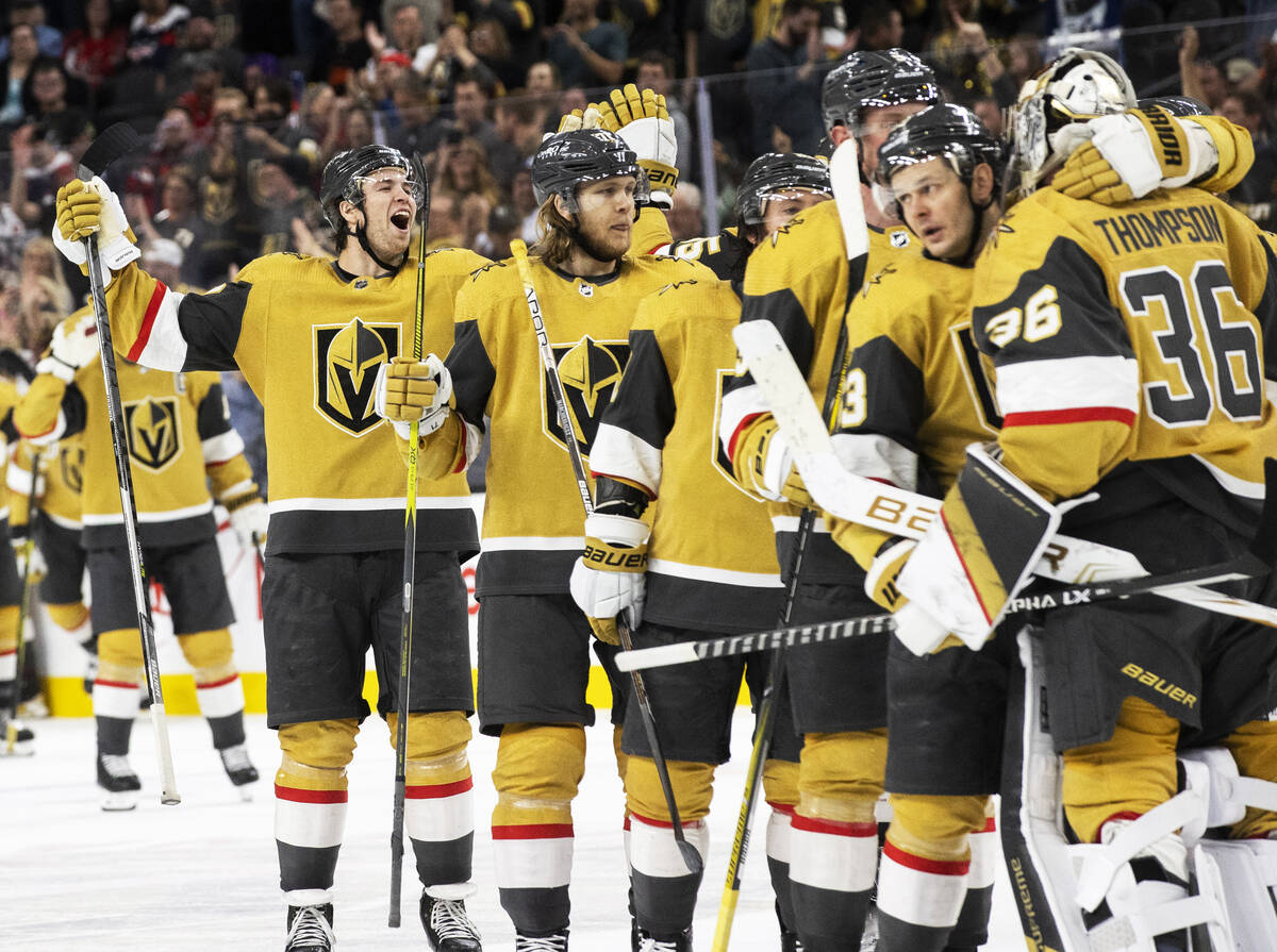 Golden Knights players celebrate after beating the Washington Capitals 4-3 in overtime during a ...