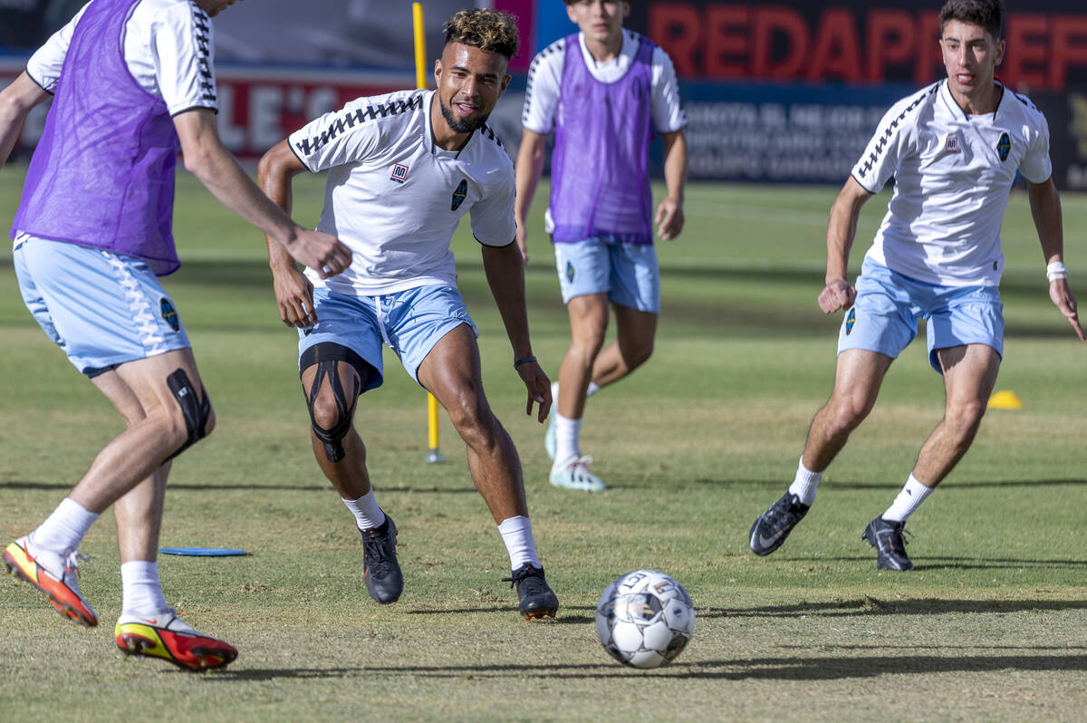 Lights FC standout Danny Trejo, center, kicks a ball past a teammate during practice at Cashman ...