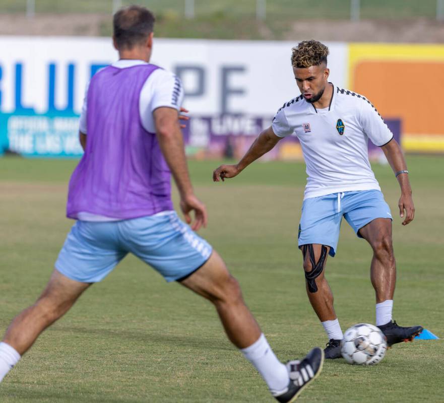 Lights FC standout Danny Trejo, right, kicks a ball around a teammate during practice at Cashma ...