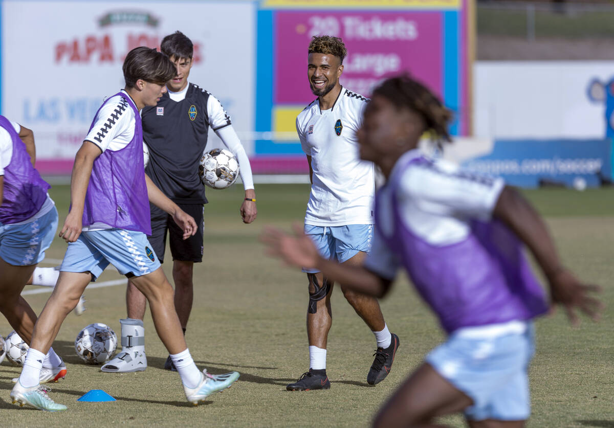 Lights FC standout Danny Trejo, right, laughs while watching teammates during practice at Cashm ...