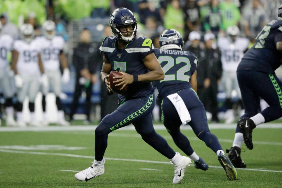 Seattle Seahawks quarterback Geno Smith drops back during the first half of the team's NFL foot ...