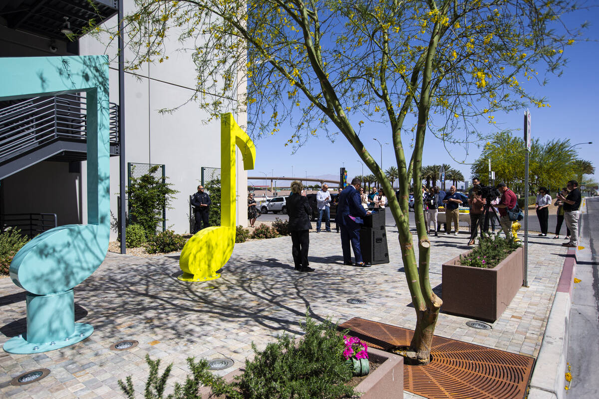 Public officials speak during the dedication of the "Larger Than Life" public art pie ...