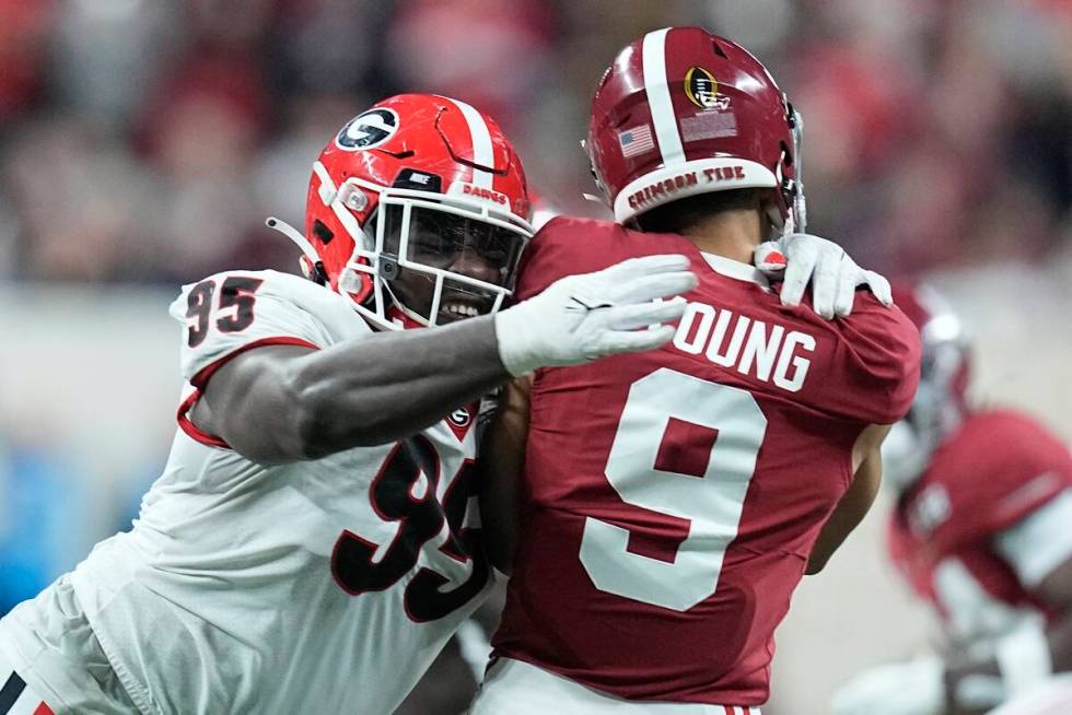 Georgia's Devonte Wyatt hits Alabama's Bryce Young as he throws during the first half of the Co ...