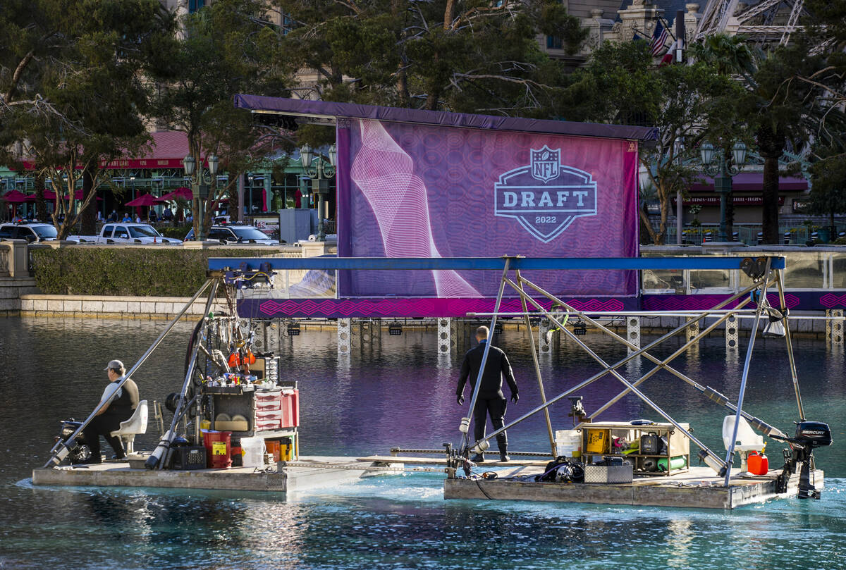 A fountain crew passes by a view deck as preparations continue for the NFL Draft 2022 stage at ...