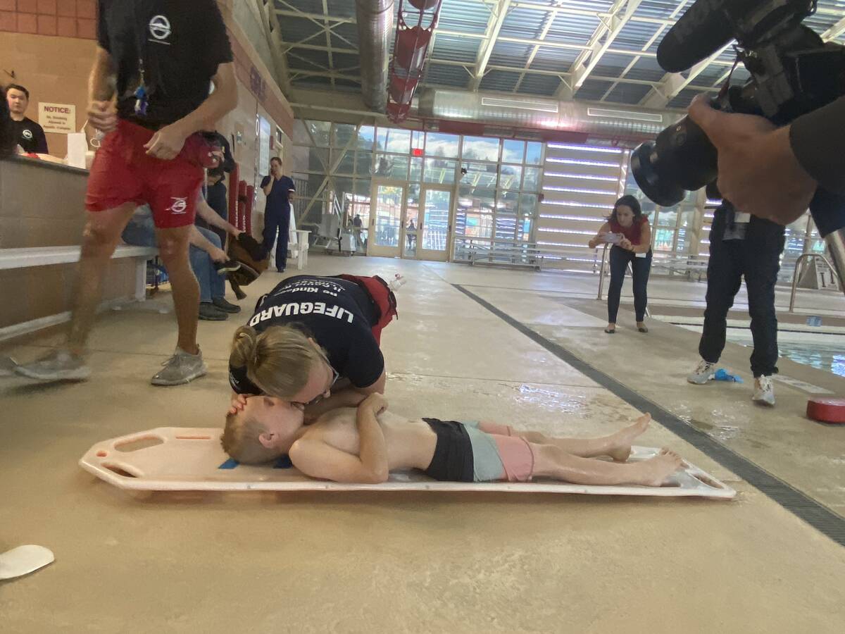 Henderson lifeguard McKenna Cooley practices rescue efforts on Haiden Law at the Whitney Ranch ...