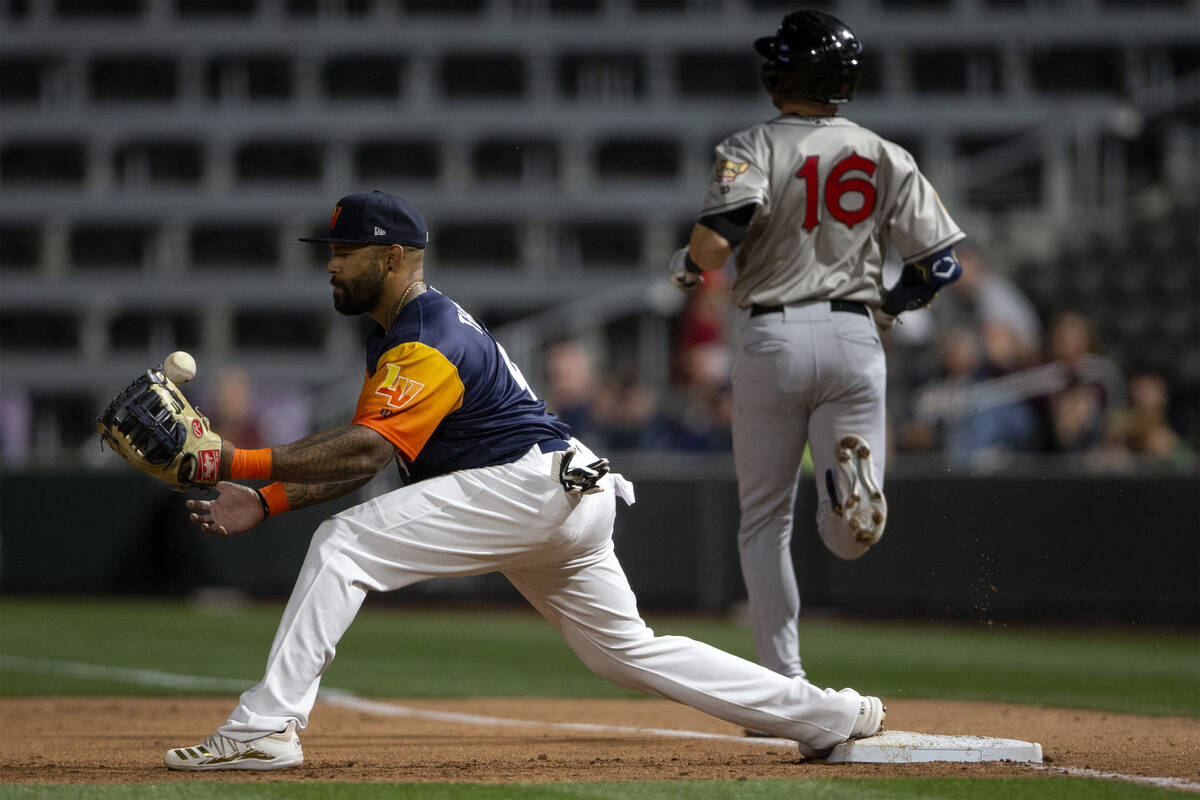 Las Vegas Aviators first baseman Eric Thames (4) attempts an out against El Paso Chihuahuas cat ...