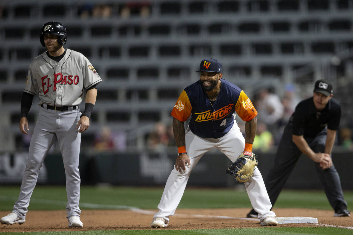 Las Vegas Aviators first baseman Eric Thames (4) smiles at the pitcher next to El Paso Chihuahu ...
