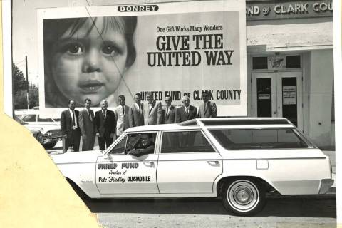 People pose for a photo outside the United Fund of Clark County office with a United Fund car, ...