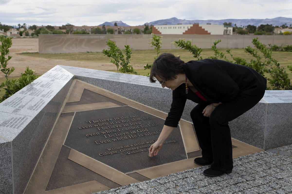 Esther Finder, president of the Holocaust Survivors Group of Southern Nevada, places a stone on ...