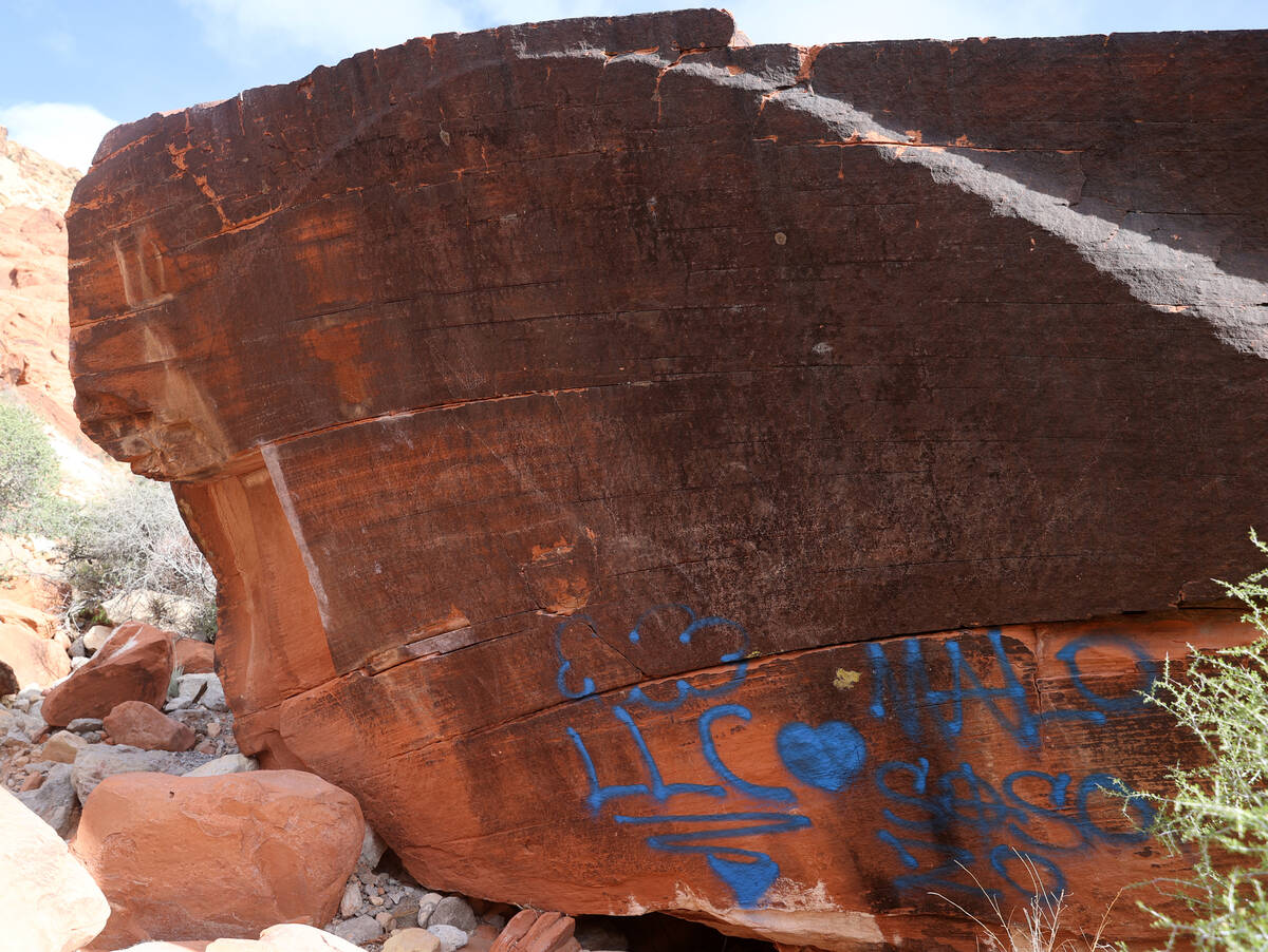 Graffiti spray painted on a rock in the Ash Creek Spring area of Red Rock Canyon National Conse ...