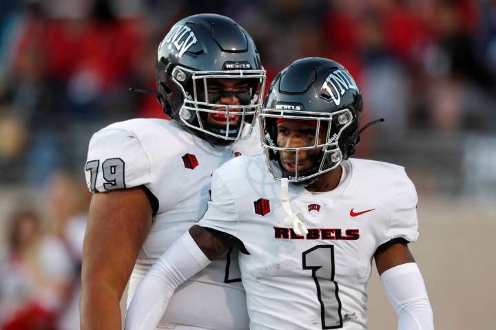 UNLV wide receiver Kyle Williams (1) is congratulated by offensive lineman Leif Fautanu (79) af ...