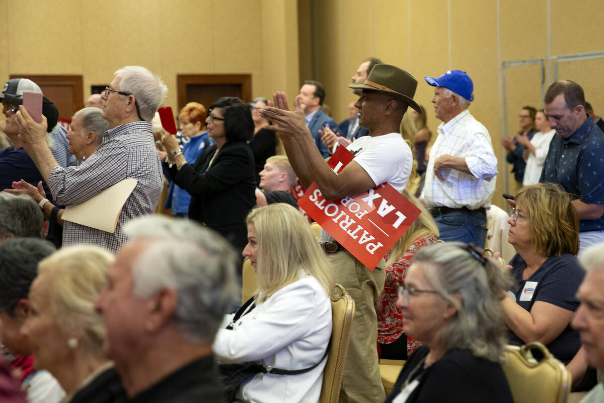 Audience members cheer for speakers including Nevada Republican U.S. Senate candidate Adam Laxa ...