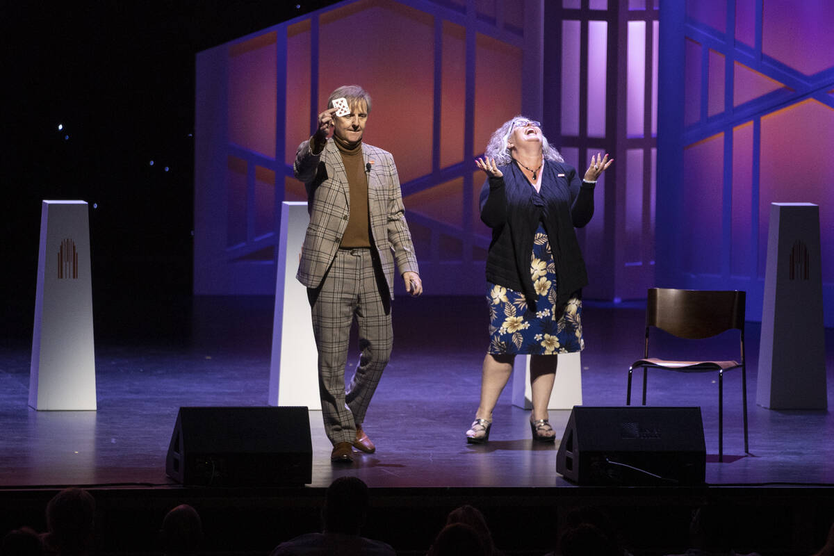 Entertainer Mac King, left, performs a magic trick with a teacher volunteer during the Heart of ...