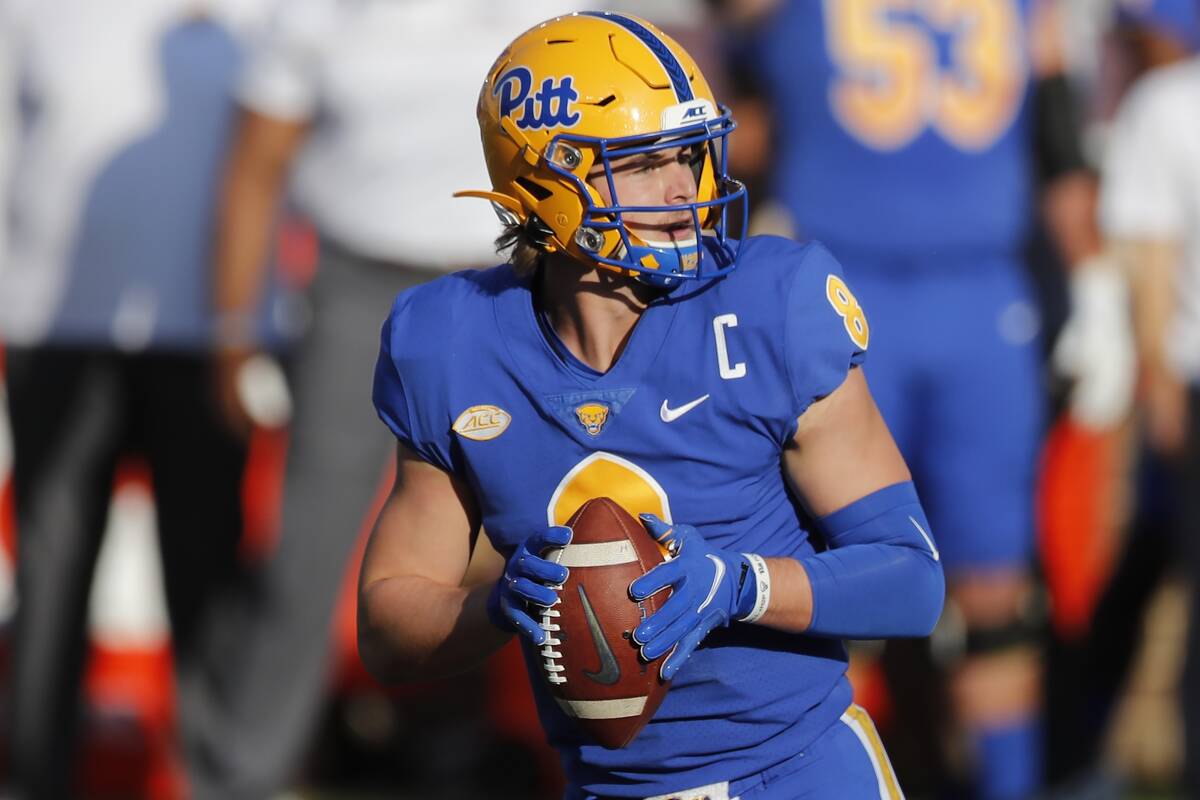 Pittsburgh quarterback Kenny Pickett drops back to pass during the first half of an NCAA colleg ...