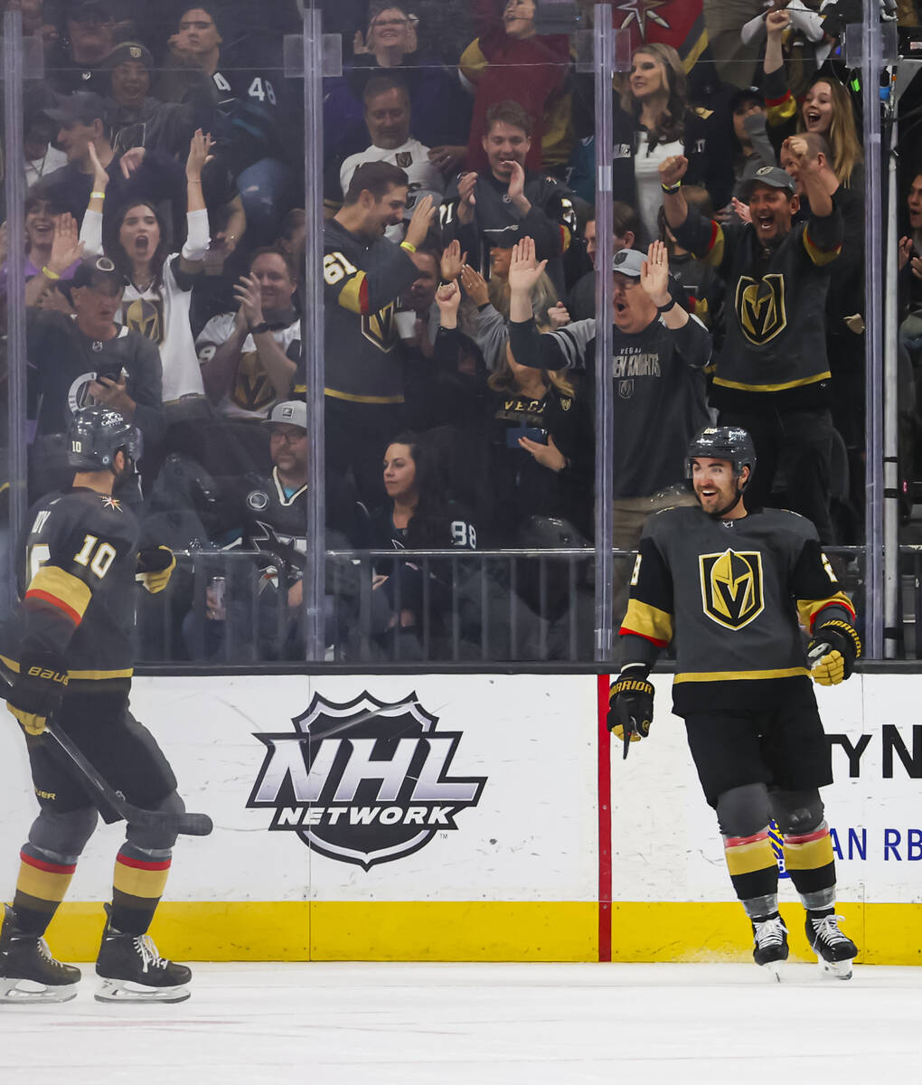 Golden Knights left wing William Carrier, right, reacts alongside center Nicolas Roy (10) after ...