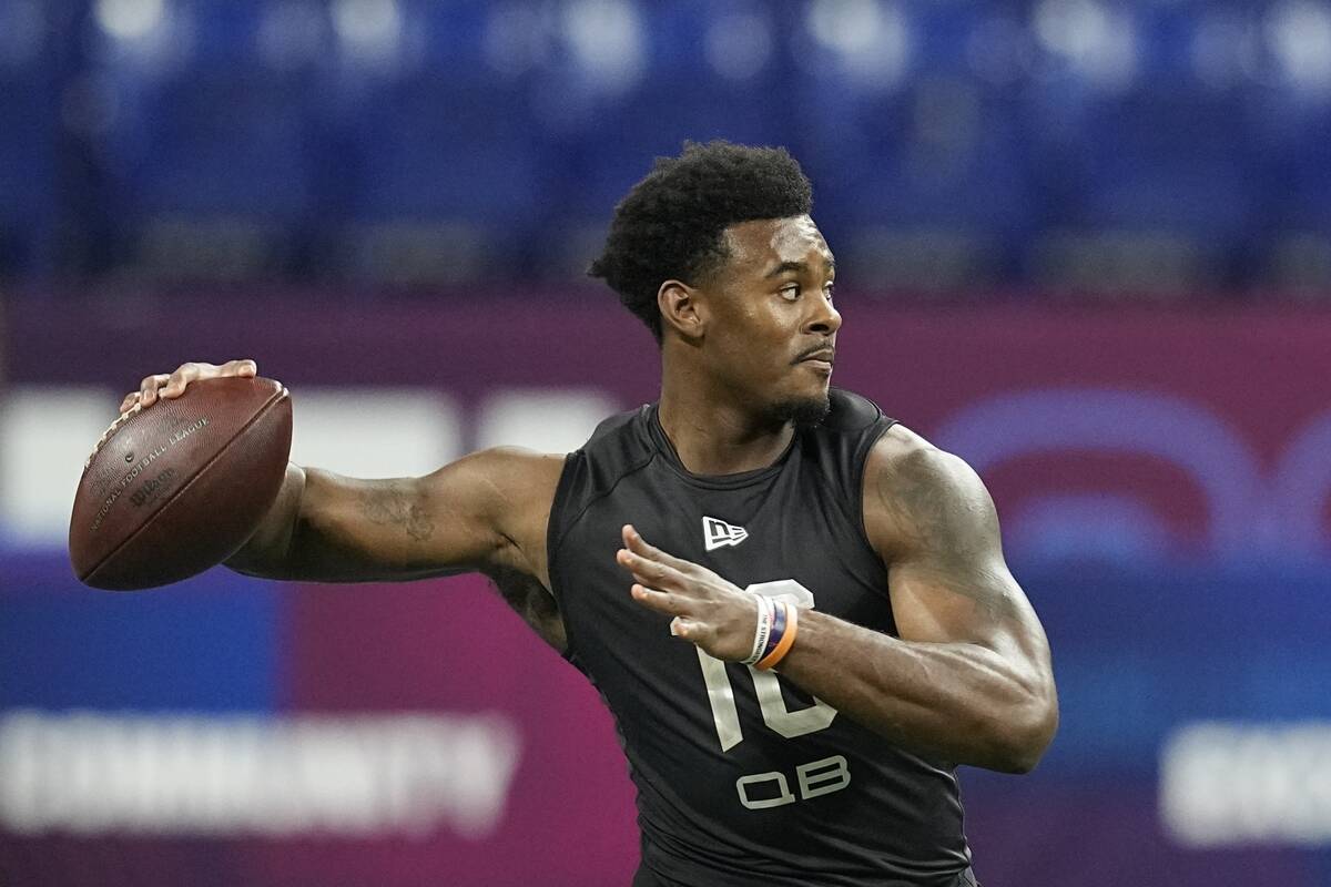 FILE - Liberty quarterback Malik Willis runs a drill during the NFL football scouting combine, ...