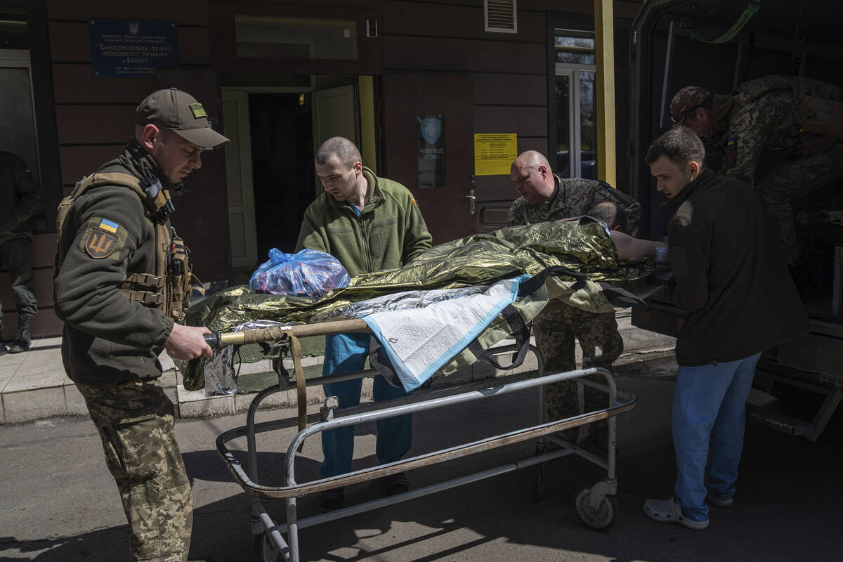 Ukrainian military medics transport an injured Ukrainian serviceman in Donetsk region, eastern ...
