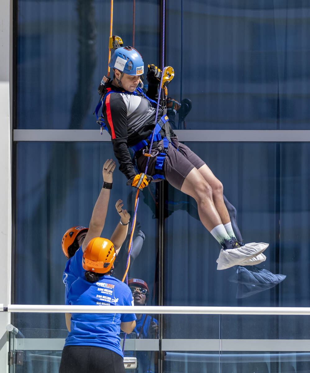 Rappeller Josh Crame with WestPac Wealth Partners nears the bottom as Over The Edge personnel a ...