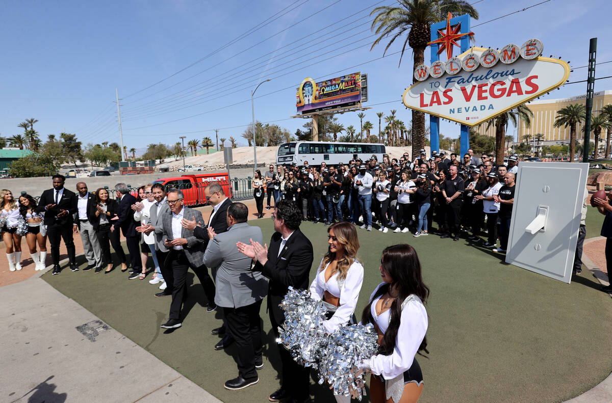 Raiders staff and public officials gather at the Welcome to Fabulous Las Vegas sign for a cerem ...