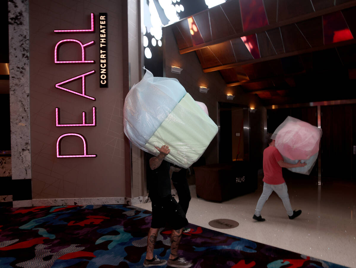 Workers move giant cupcakes at the Palms in Las Vegas Monday, April 25, 2022. The 766-room off- ...