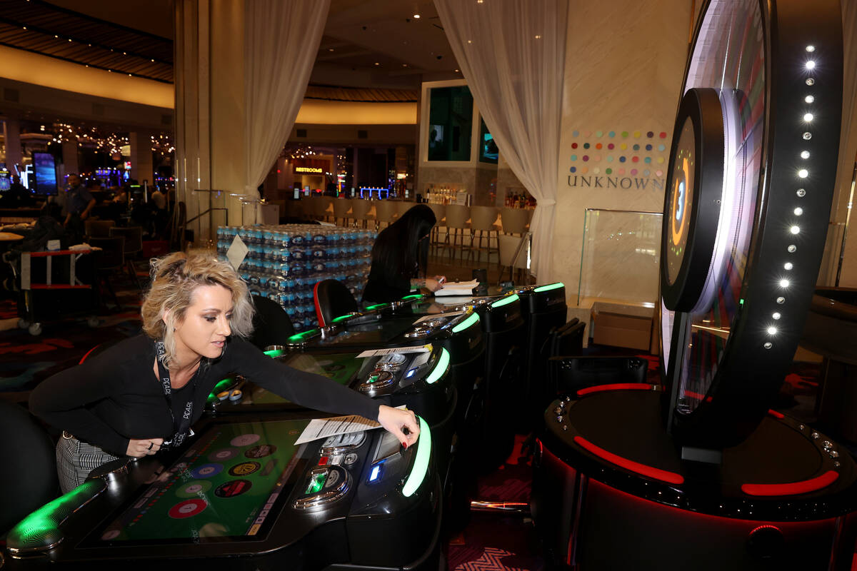 Shera Hall, left, and Tanya Phelps prepare gaming machines at the Palms in Las Vegas Monday, Ap ...