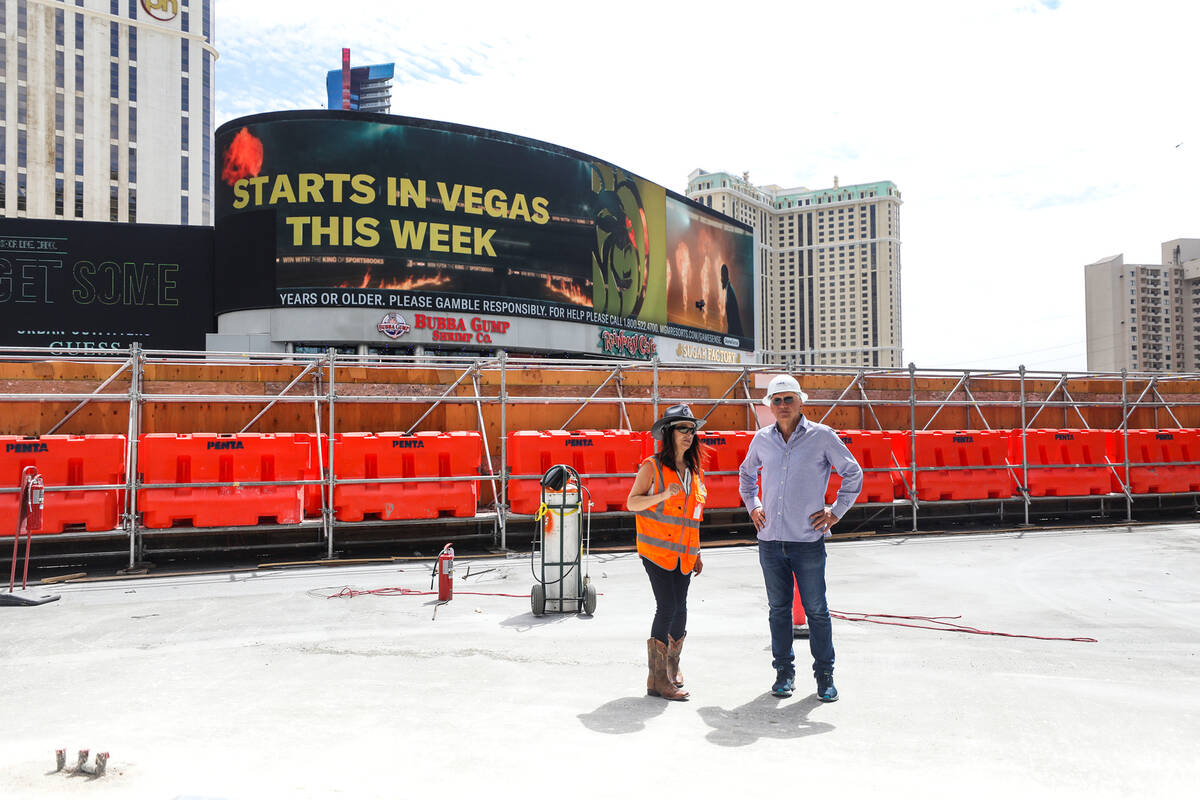 Assistant Project Manager Lori Morales, left, speaks with developer Paul Kanavos, right, on a t ...