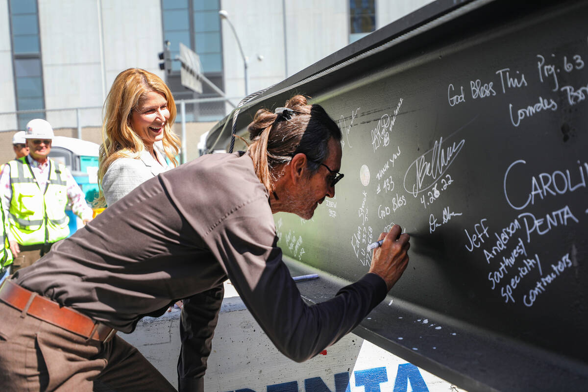 Developer Brett Torino signs a beam for the topping off ceremony of Project63, a new retail com ...