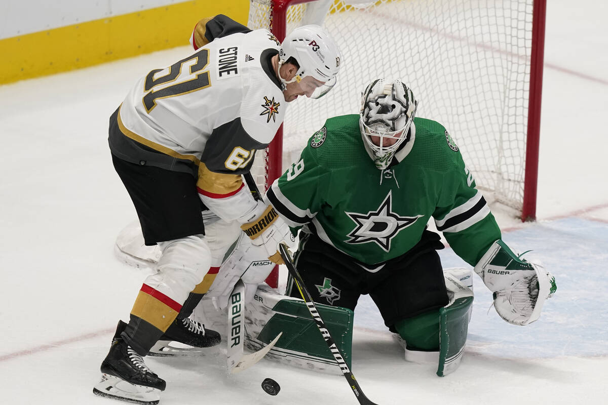 Dallas Stars goaltender Jake Oettinger (29) defends the goal against Vegas Golden Knights right ...