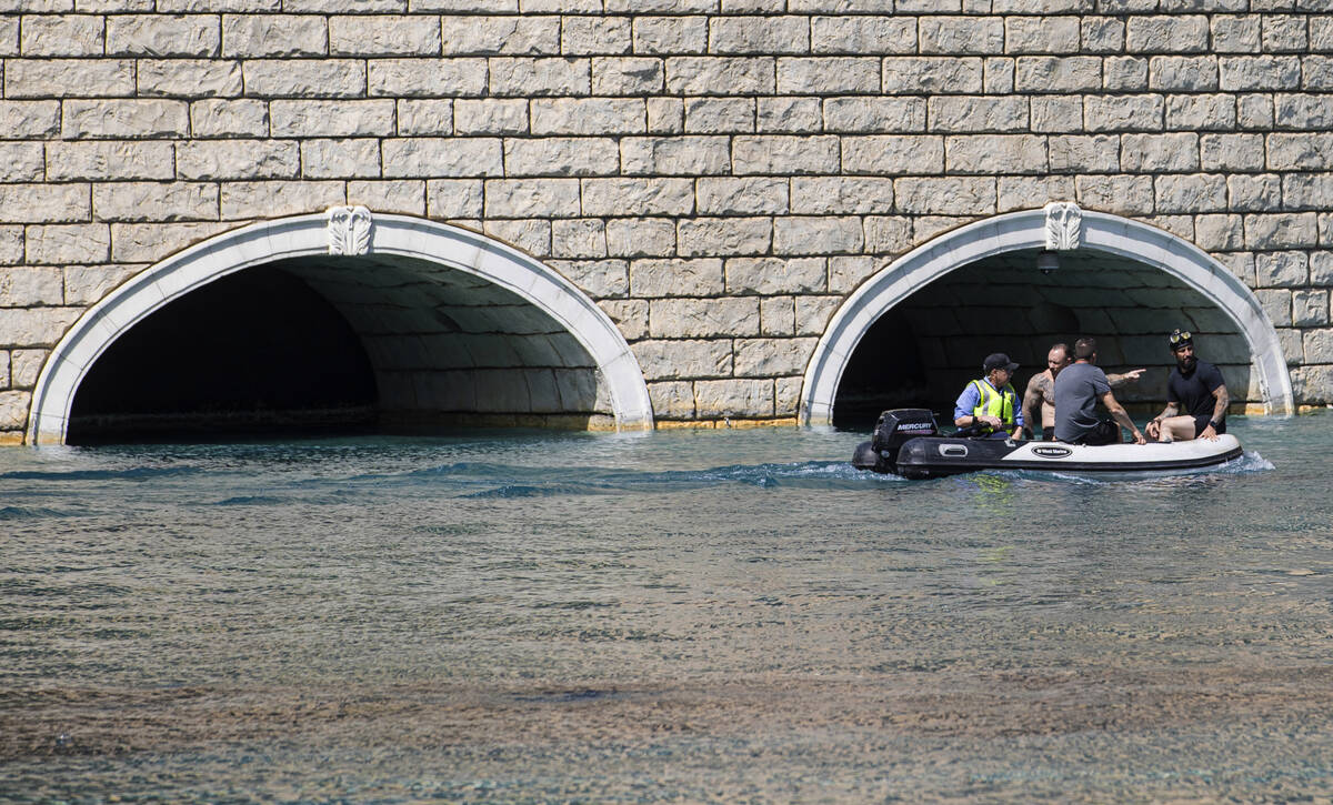 Workers scan the perimeter of the NFL Draft Red Carpet Stage at the Bellagio Fountains on Tuesd ...