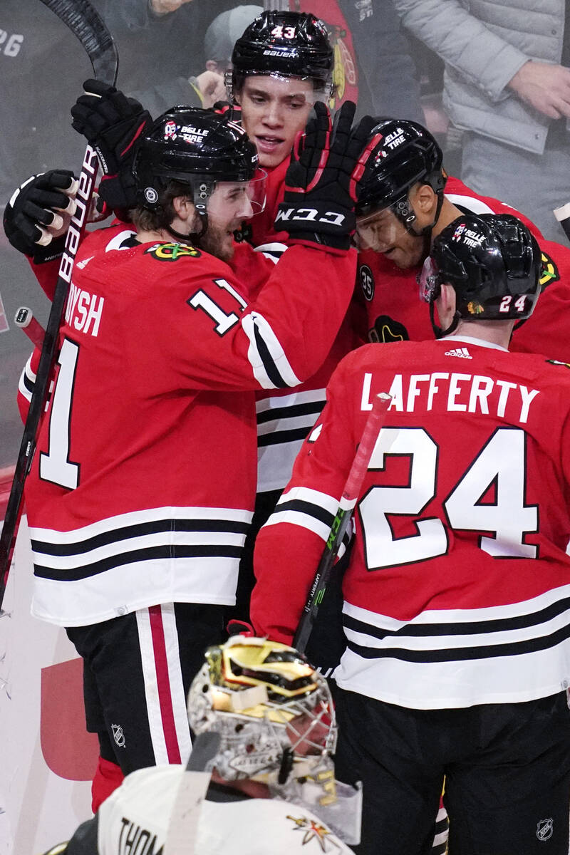 Chicago Blackhawks right wing Taylor Raddysh (11) celebrates with teammates after scoring a goa ...