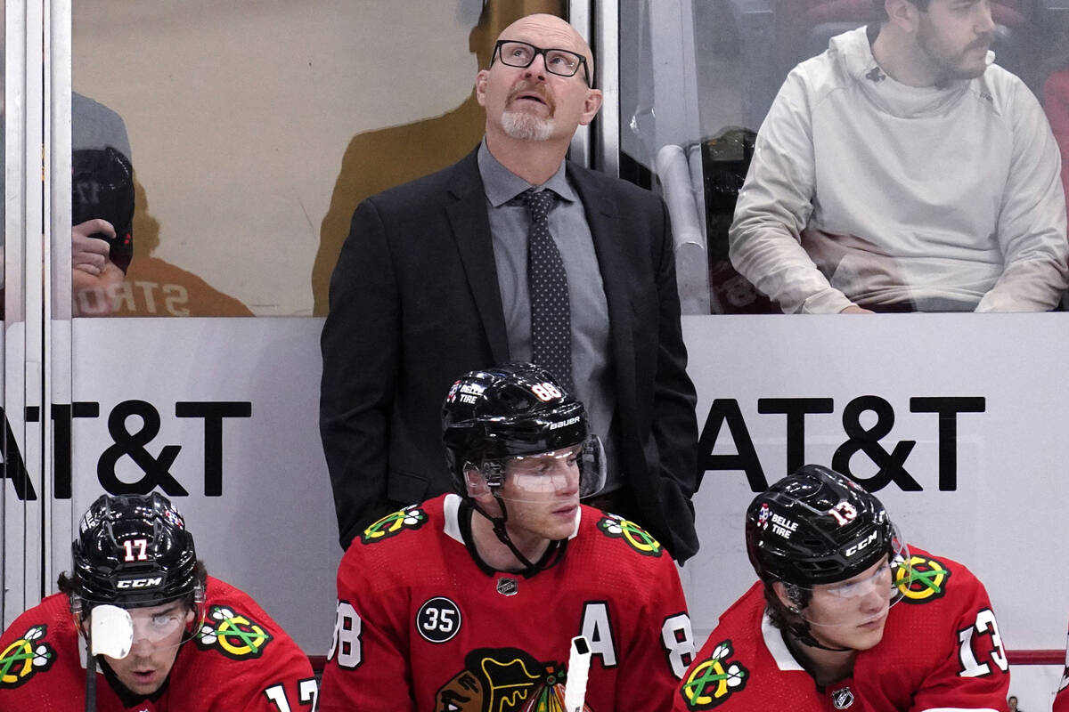 Chicago Blackhawks interim head coach Derek King, top, looks up the scoreboard during the first ...