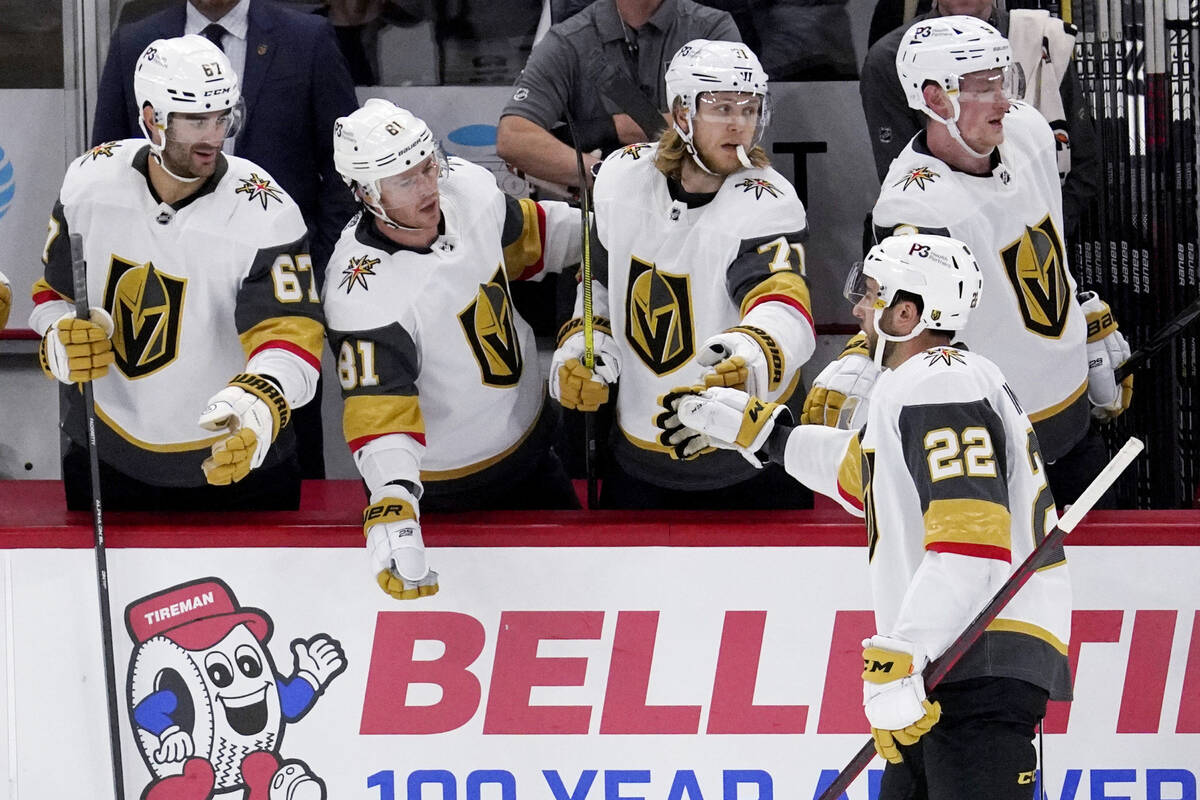 Vegas Golden Knights center Michael Amadio (22) celebrates with teammates after scoring a goal ...