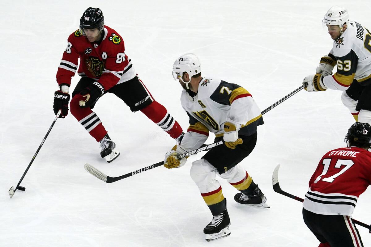 Chicago Blackhawks right wing Patrick Kane, left, controls the puck against Vegas Golden Knight ...
