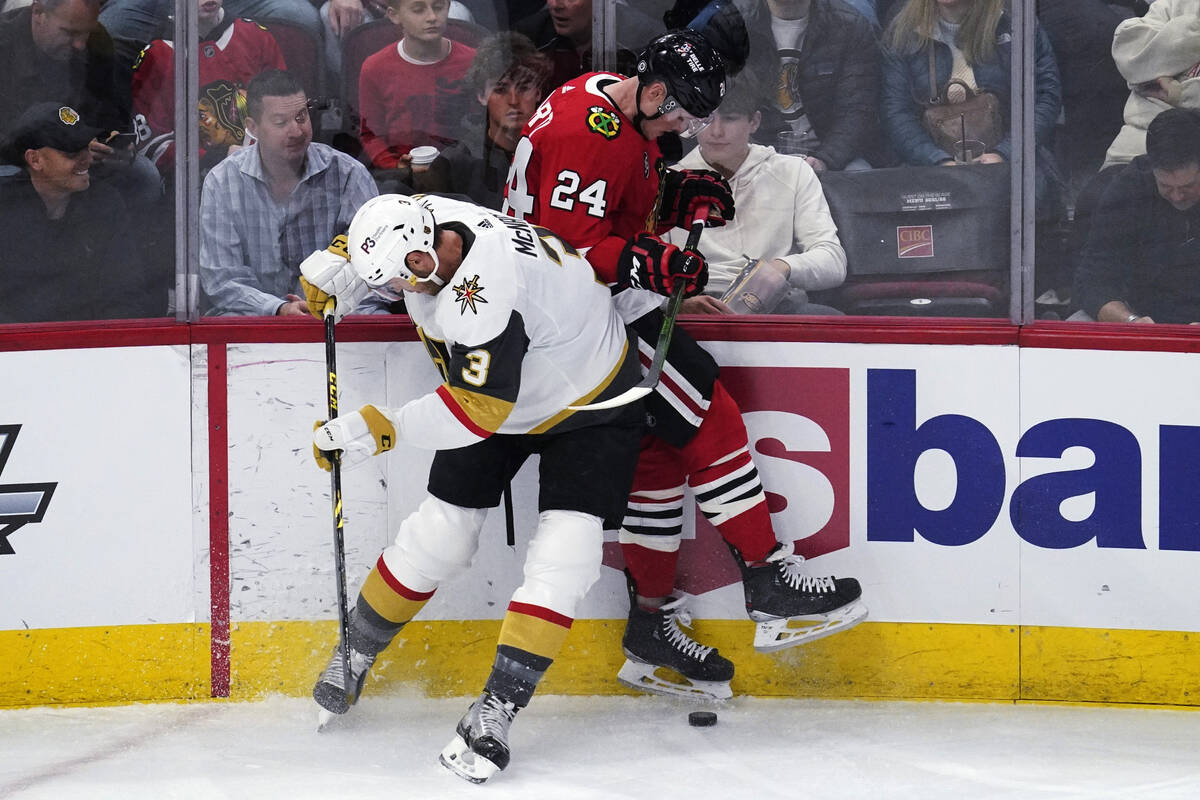 Chicago Blackhawks center Sam Lafferty, right, is checked by Vegas Golden Knights defenseman Br ...