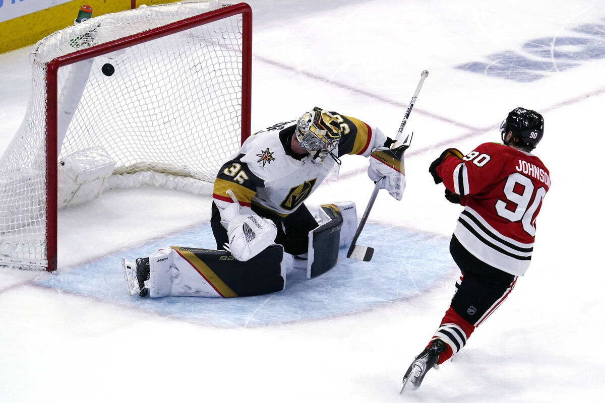 Chicago Blackhawks center Tyler Johnson, right, scores against Vegas Golden Knights goaltender ...