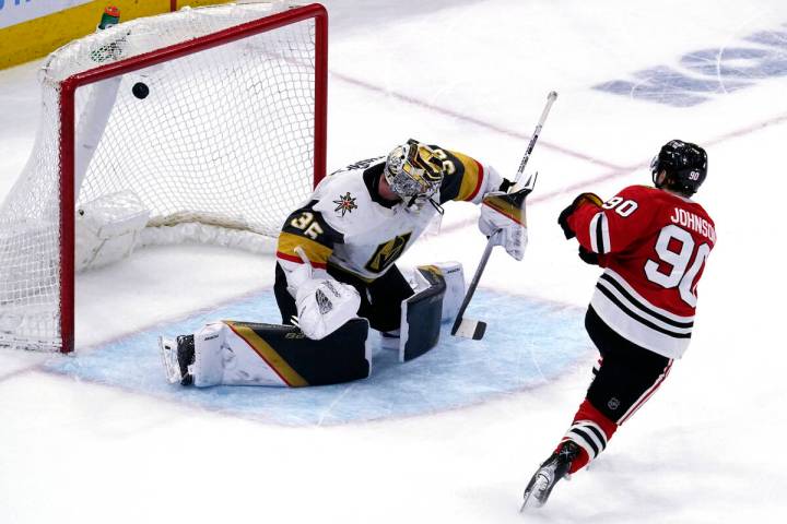 Chicago Blackhawks center Tyler Johnson, right, scores against Vegas Golden Knights goaltender ...