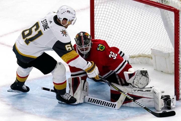 Chicago Blackhawks goaltender Kevin Lankinen, right, makes a save against Vegas Golden Knights ...