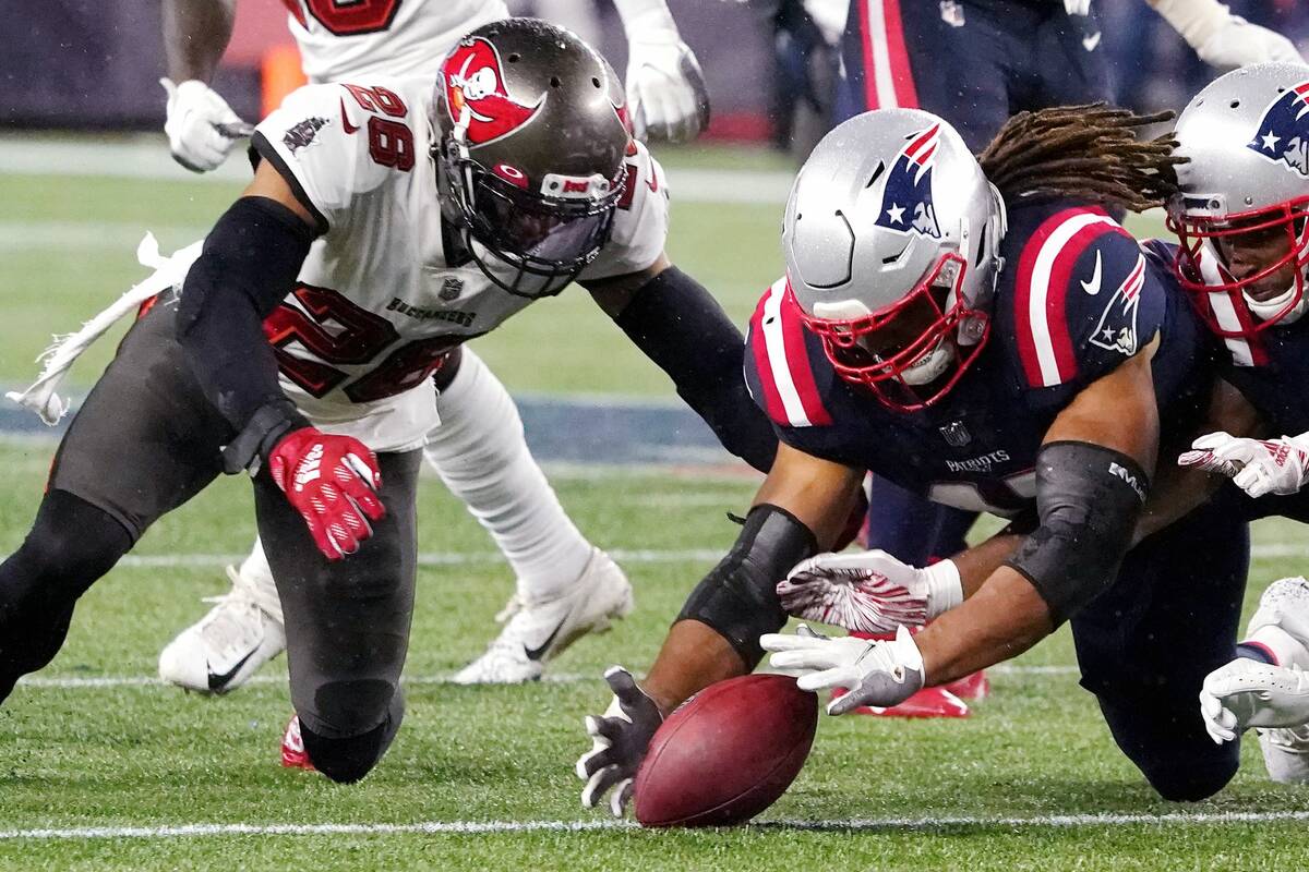 New England Patriots fullback Jakob Johnson, right, dives for the ball against Tampa Bay Buccan ...